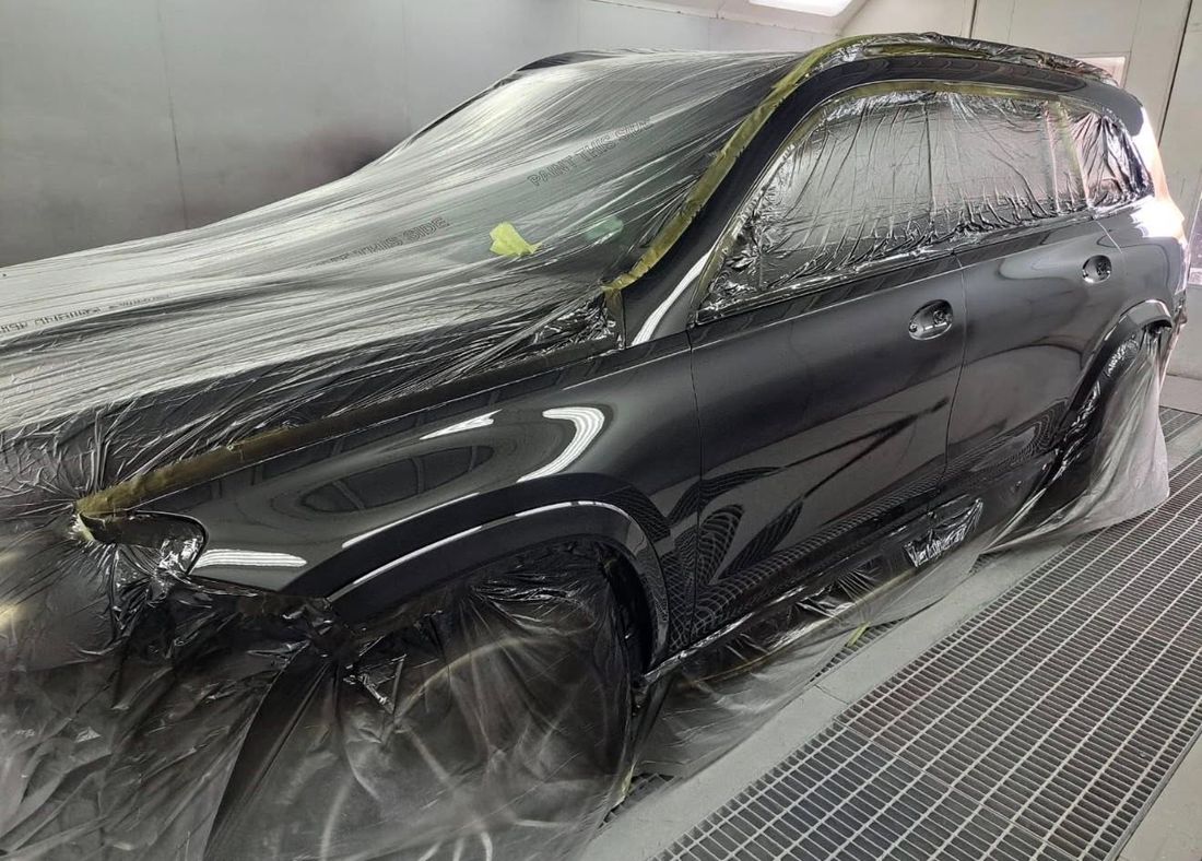 A Mercedes-Benz GLS in the paint booth for panel repair at Mobile Dent Pro